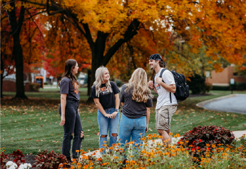 Students outside during the fall season